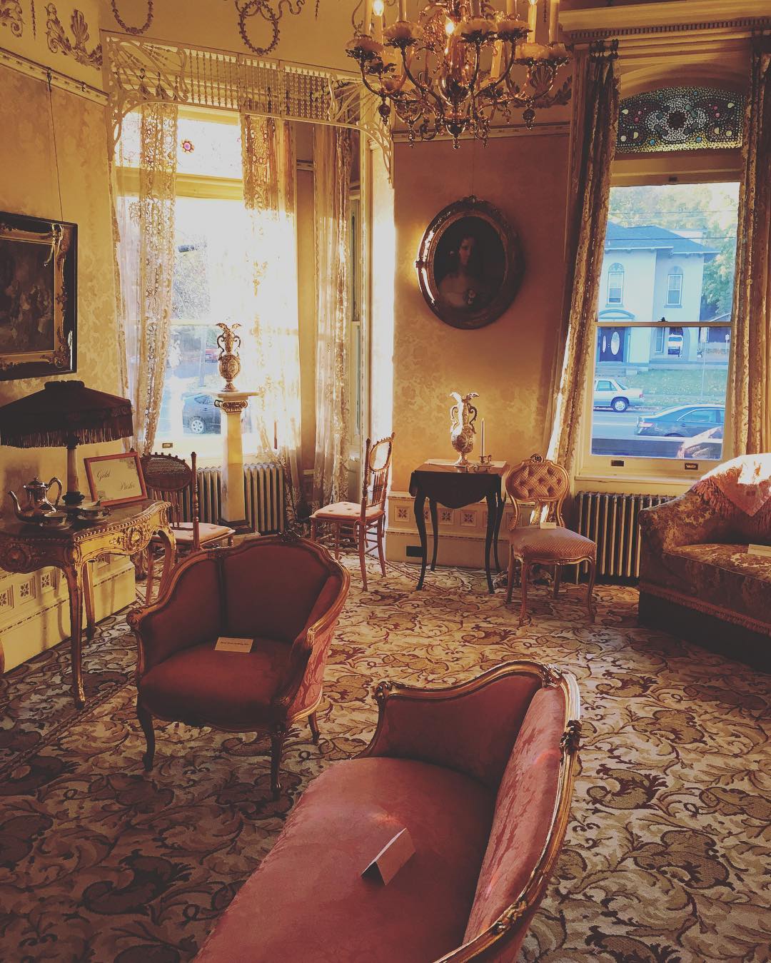 1890 House Parlor Victorian parlor with gold walls and pink couches.