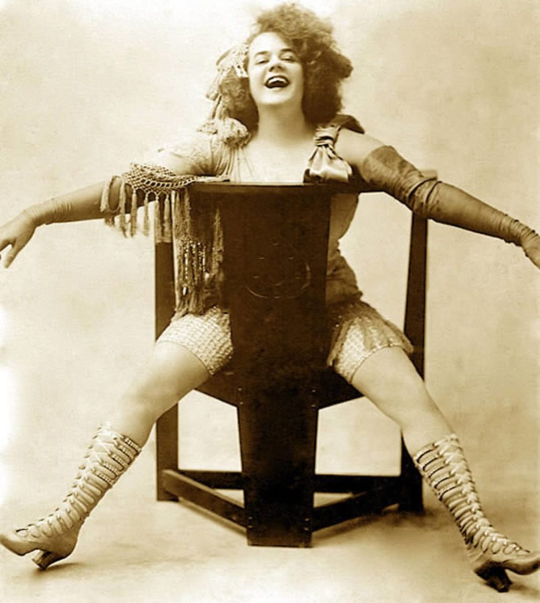 Burlesque dancer, posed in chair.